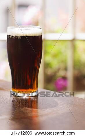 Glass of Irish ale in pub View Large Photo Image Stock Photograph - Glass of Irish ale in pub. Fotosearch
