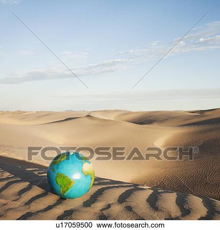 Stock Image - Globe in desert. Fotosearch