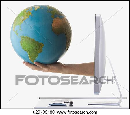 Stock Image - Globe on arm extended out of computer monitor. Fotosearch