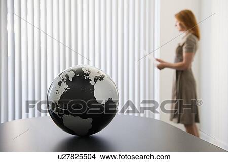 Picture - Globe on conference room table. Fotosearch