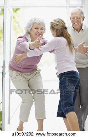 Granddaughter hugging her grandmother View Large Photo Image Stock Image - Granddaughter hugging her grandmother. Fotosearch