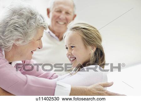 Granddaughter hugging her grandmother View Large Photo Image Stock Image - Granddaughter hugging her grandmother. Fotosearch