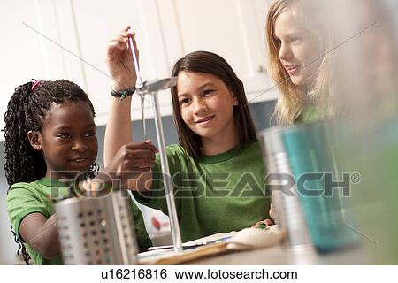 Stock Photograph - Group of children looking at model windmill. Fotosearch