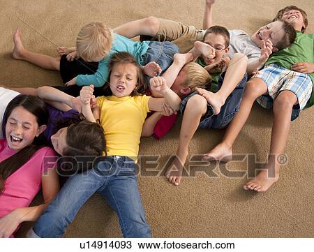 Stock Image - Group of children playing on floor. Fotosearch