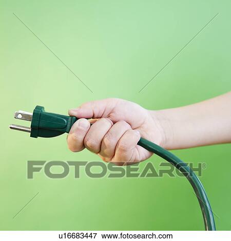 Stock Photo - Hand holding electrical cord. Fotosearch