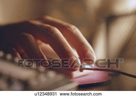 Stock Image - Hand on a computer mouse. Fotosearch