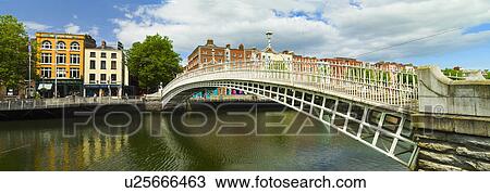 Stock Image - Ha'penny bridge and River Liffey. Fotosearch