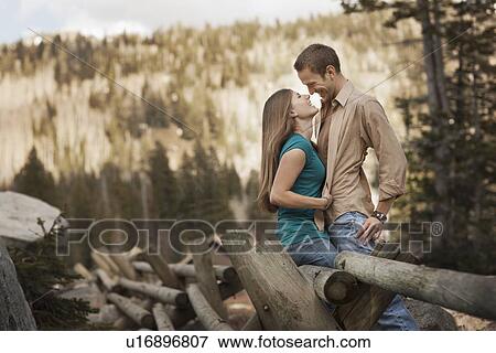 Stock Photo - Happy couple embracing in rural setting. Fotosearch
