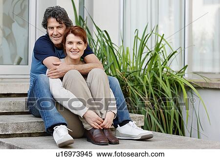 Happy couple sitting on steps together View Large Photo Image Stock Photography - Happy couple sitting on steps together. Fotosearch