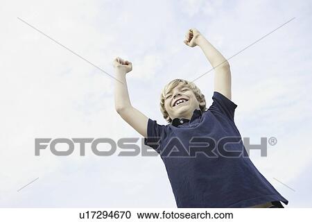 Happy young boy raising his arms in the air View Large Photo Image Stock Image - Happy young boy raising his arms in the air. Fotosearch