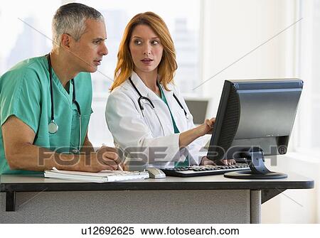 Stock Photography - Healthcare professionals working at computer. Fotosearch