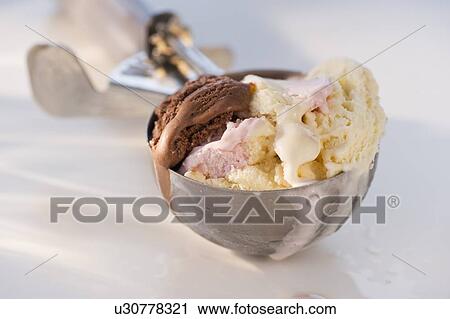 Ice cream in scooper View Large Photo Image Stock Image - Ice cream in scooper. Fotosearch