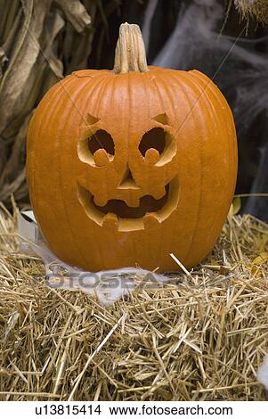Picture - Jack-o-lantern on bale of hay. Fotosearch
