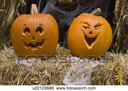 Jack-o-lanterns on bale of hay View Large Photo Image Stock Photo - Jack-o-lanterns on bale of hay. Fotosearch
