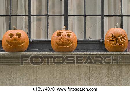 Stock Image - Jack-o-lanterns on window sill. Fotosearch