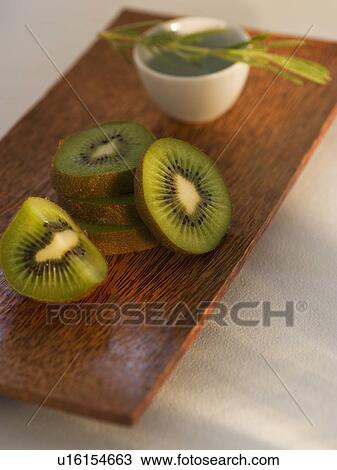 Kiwi slices on wooden tray View Large Photo Image Stock Image - Kiwi slices on wooden tray. Fotosearch