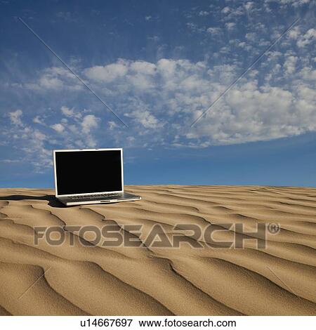 Stock Photo - Laptop computer on desert sand. Fotosearch