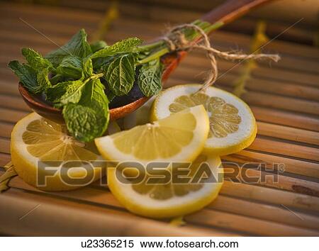 Lemon slices mint and wooden spoon View Large Photo Image Stock Photography - Lemon slices mint and wooden spoon. Fotosearch
