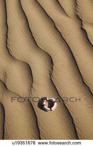 Stock Photo - Lifebuoy in desert. Fotosearch
