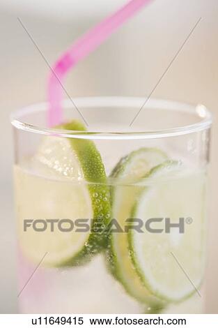 Stock Photography - Lime slices in glass of water. Fotosearch