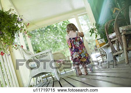 Little girl pushing stroller on porch View Large Photo Image Stock Photography - Little girl pushing stroller on porch. Fotosearch