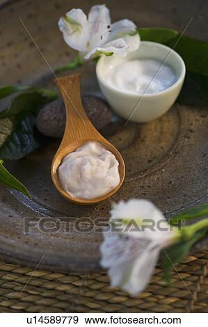 Stock Photo - Lotion in wooden spoon. Fotosearch