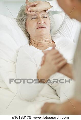 Man caring for senior woman with a headache View Large Photo Image Stock Photography - Man caring for senior woman with a headache. Fotosearch