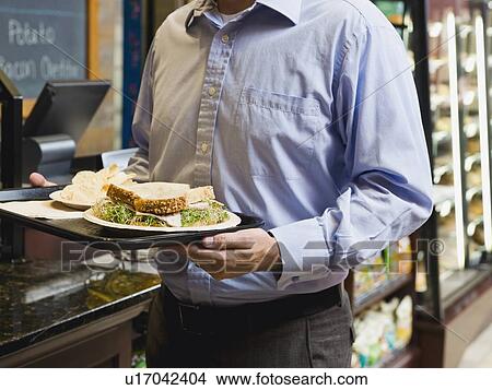 Man carrying sandwich on tray View Large Photo Image Picture - Man carrying sandwich on tray. Fotosearch