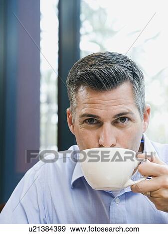 Stock Photo - Man drinking coffee. Fotosearch
