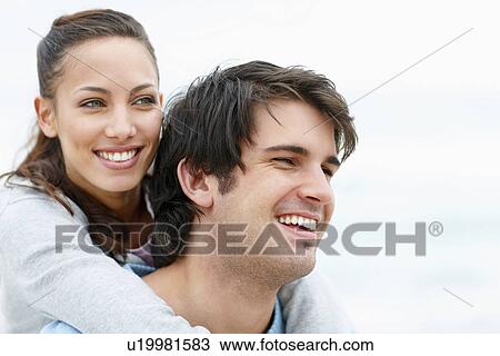 Man giving woman a piggy back ride View Large Photo Image Stock Image - Man giving woman a piggy back ride. Fotosearch
