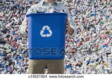 Picture - Man holding blue bin. Fotosearch