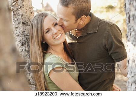 Stock Image - Man kissing his girlfriend. Fotosearch
