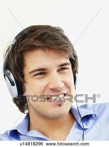 Stock Photograph - Man listening to music on headphones. Fotosearch