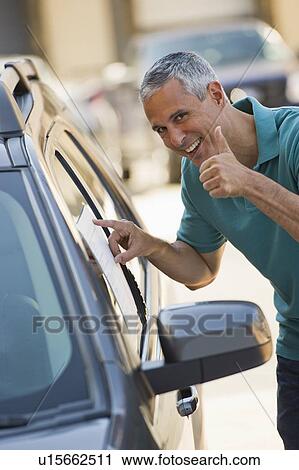 Man looking at new car View Large Photo Image Stock Image - Man looking at new car. Fotosearch