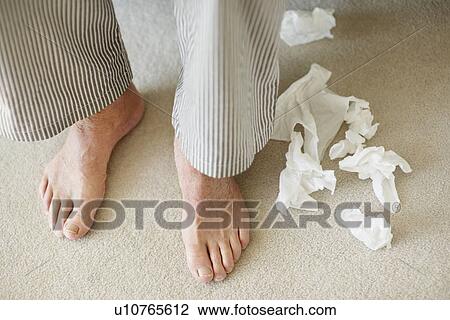 Man's feet surrounded by crumpled tissues View Large Photo Image Stock Image - Man's feet surrounded by crumpled tissues. Fotosearch