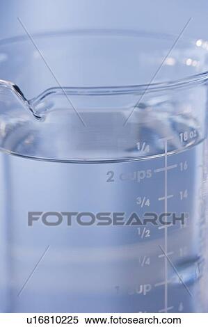 Stock Photography - Measuring cup full of water. Fotosearch