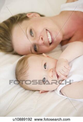 Mother and baby lying down together View Large Photo Image Stock Image - Mother and baby lying down together. Fotosearch