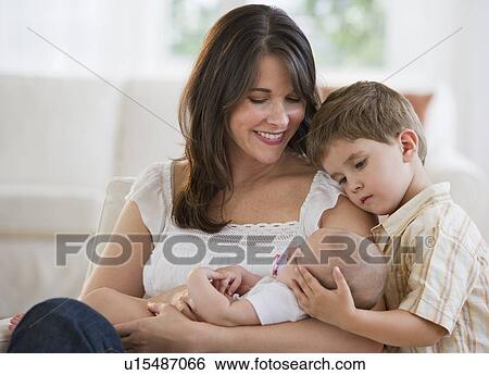 Stock Photograph - Mother and her two children. Fotosearch