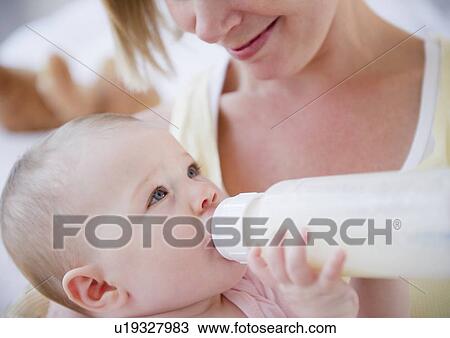 Mother feeding her baby View Large Photo Image Stock Image - Mother feeding her baby. Fotosearch