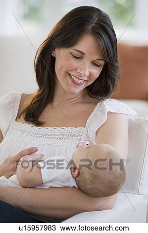 Mother holding her baby View Large Photo Image Stock Image - Mother holding her baby. Fotosearch