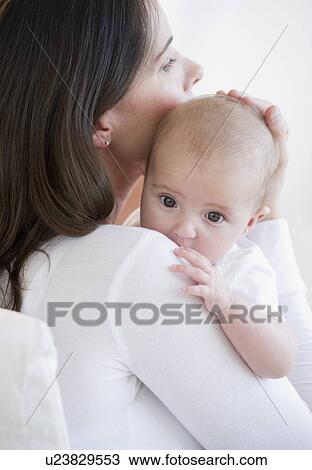 Stock Image - Mother holding her baby. Fotosearch