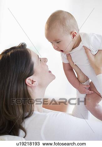 Mother playing with her baby View Large Photo Image Stock Image - Mother playing with her baby. Fotosearch