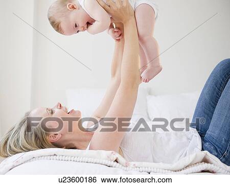 Mother playing with her baby View Large Photo Image Stock Photograph - Mother playing with her baby. Fotosearch