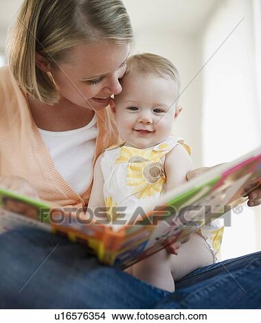 Picture - Mother reading book to her baby daughter. Fotosearch