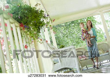 Mother walking on porch with her daughter View Large Photo Image Stock Image - Mother walking on porch with her daughter. Fotosearch