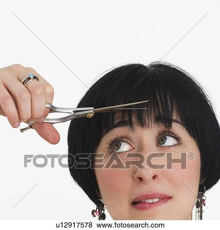 Stock Photo - Nervous woman watching her hair being cut. Fotosearch