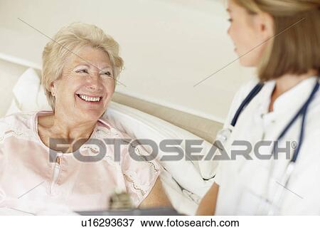 Stock Photo - Nurse and senior patient. Fotosearch