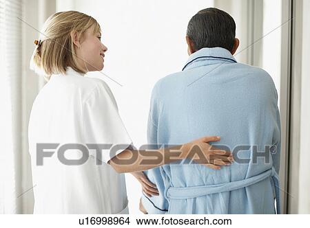 Picture - Nurse assisting patient with a walker. Fotosearch