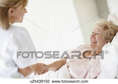 Nurse caring for a senior woman View Large Photo Image Stock Image - Nurse caring for a senior woman. Fotosearch