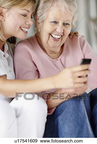 Stock Photo - Nurse helping woman send a text message. Fotosearch
